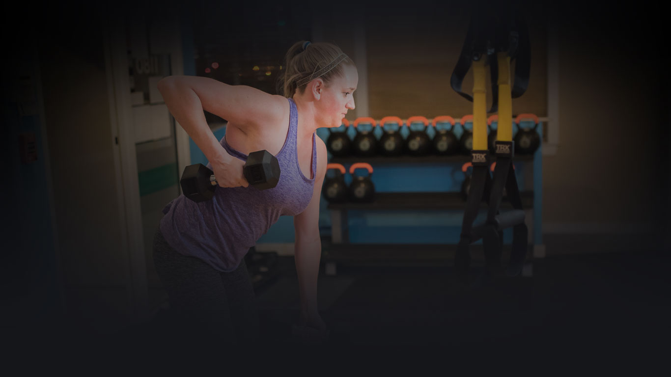 woman exercising with dumbbell in hand