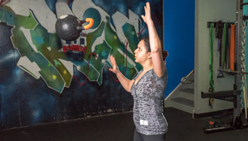 woman exercising with kettlebell in gym